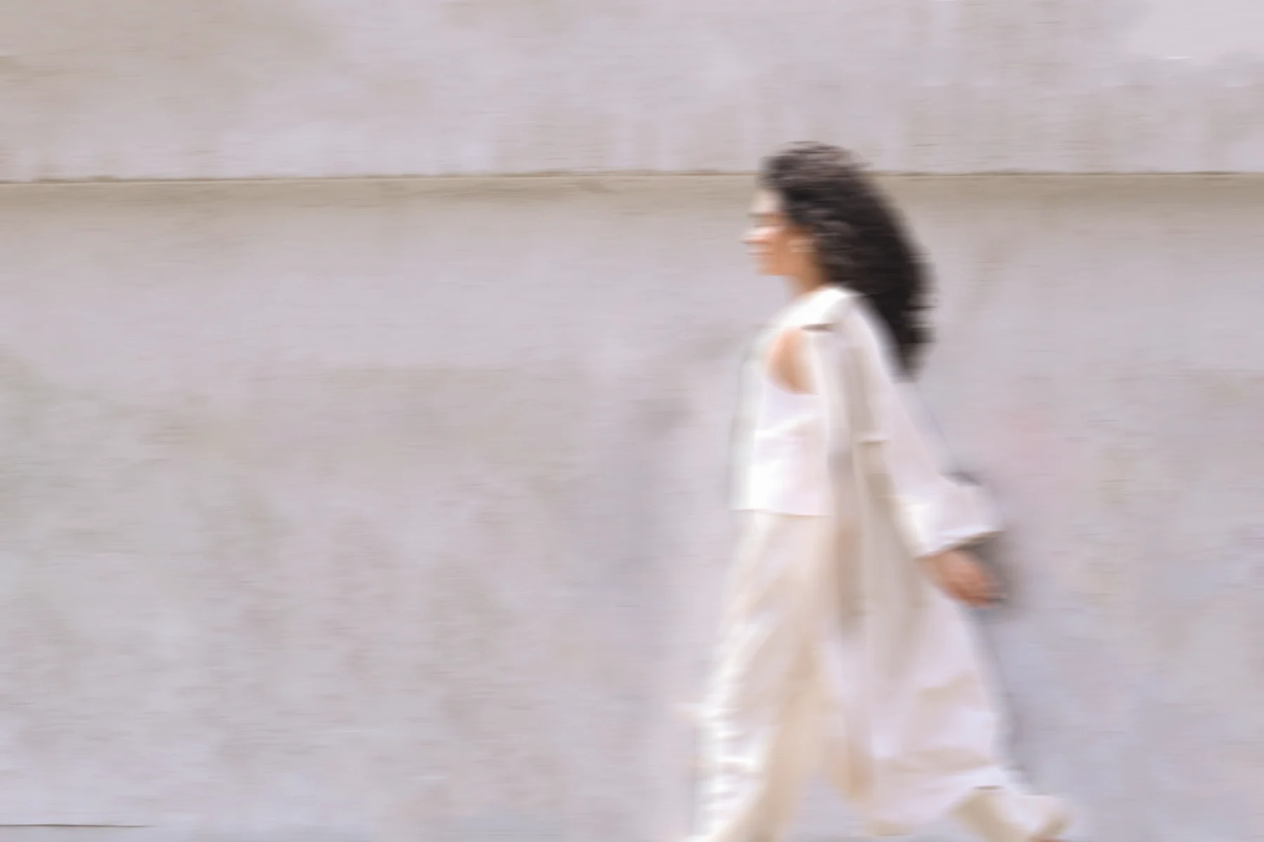 Movement study: a figure walking through an open urban space